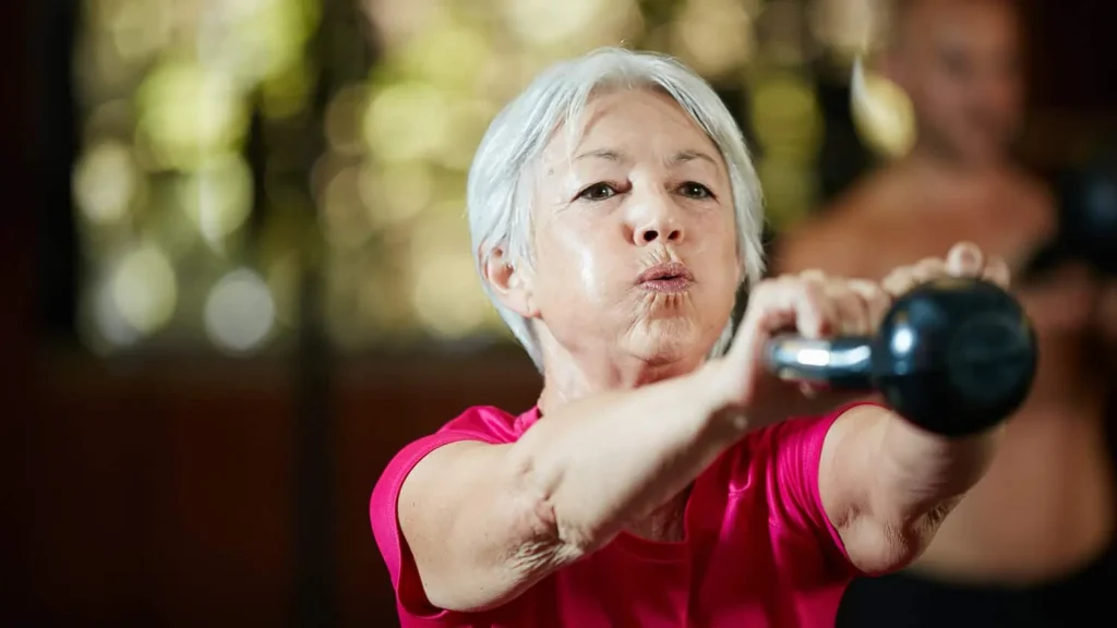Toning Bingo Wings: Effective Exercises and Tips for Achieving Sleeker Arms 2 Person performing arm exercises with dumbbells Lowestoft